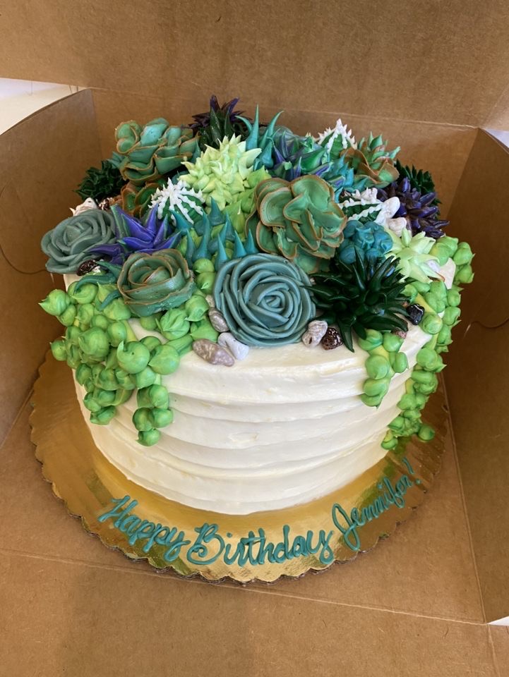 Custom birthday cake decorated with flowers on top